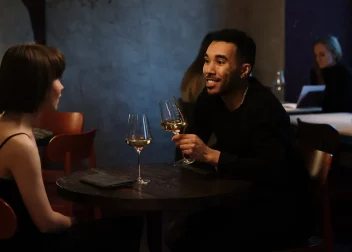 couple drinking wine at dimly lit table